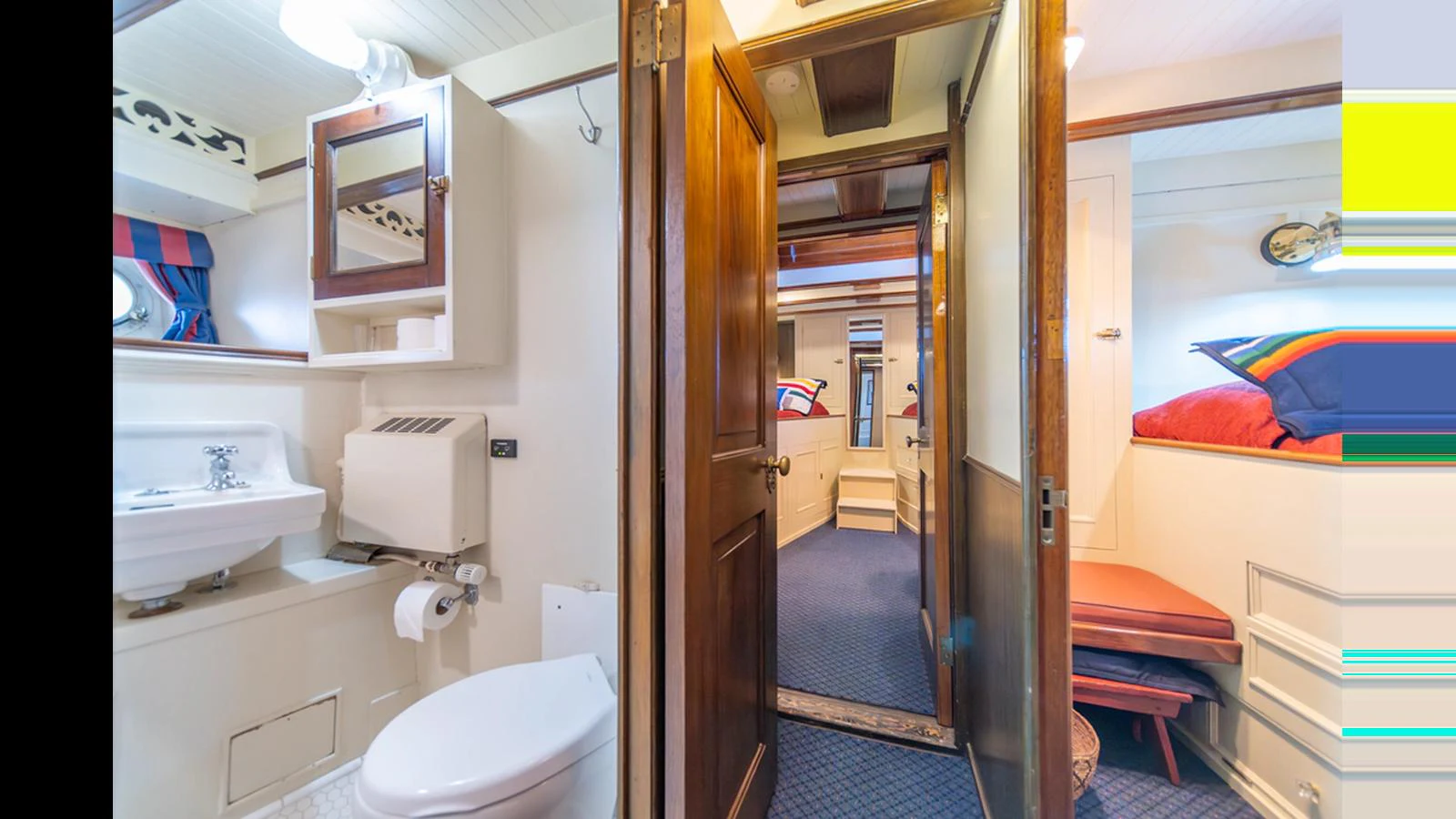 A cozy and well-appointed yacht interior featuring a bathroom and a view into a cabin area. aboard BLUE PETER Yacht for Sale