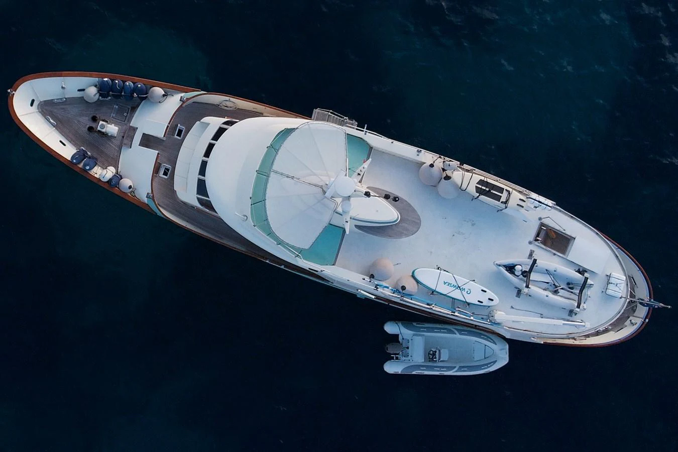 An aerial view of a luxurious yacht anchored in calm waters. aboard KALANI Yacht for Sale