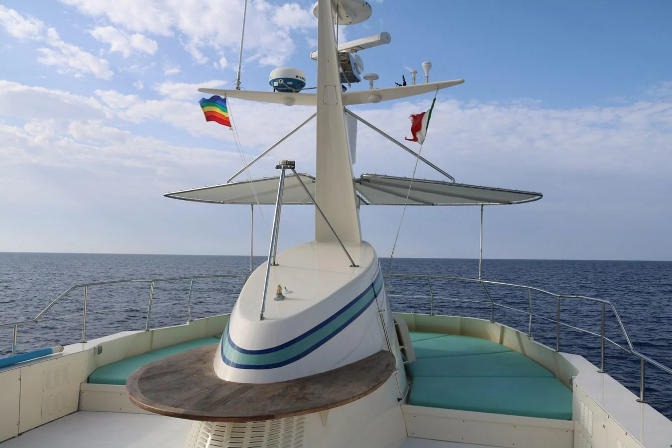 The yacht's flybridge offers a serene and expansive view of the open sea, complemented by comfortable seating and a sleek design. aboard KALANI Yacht for Sale