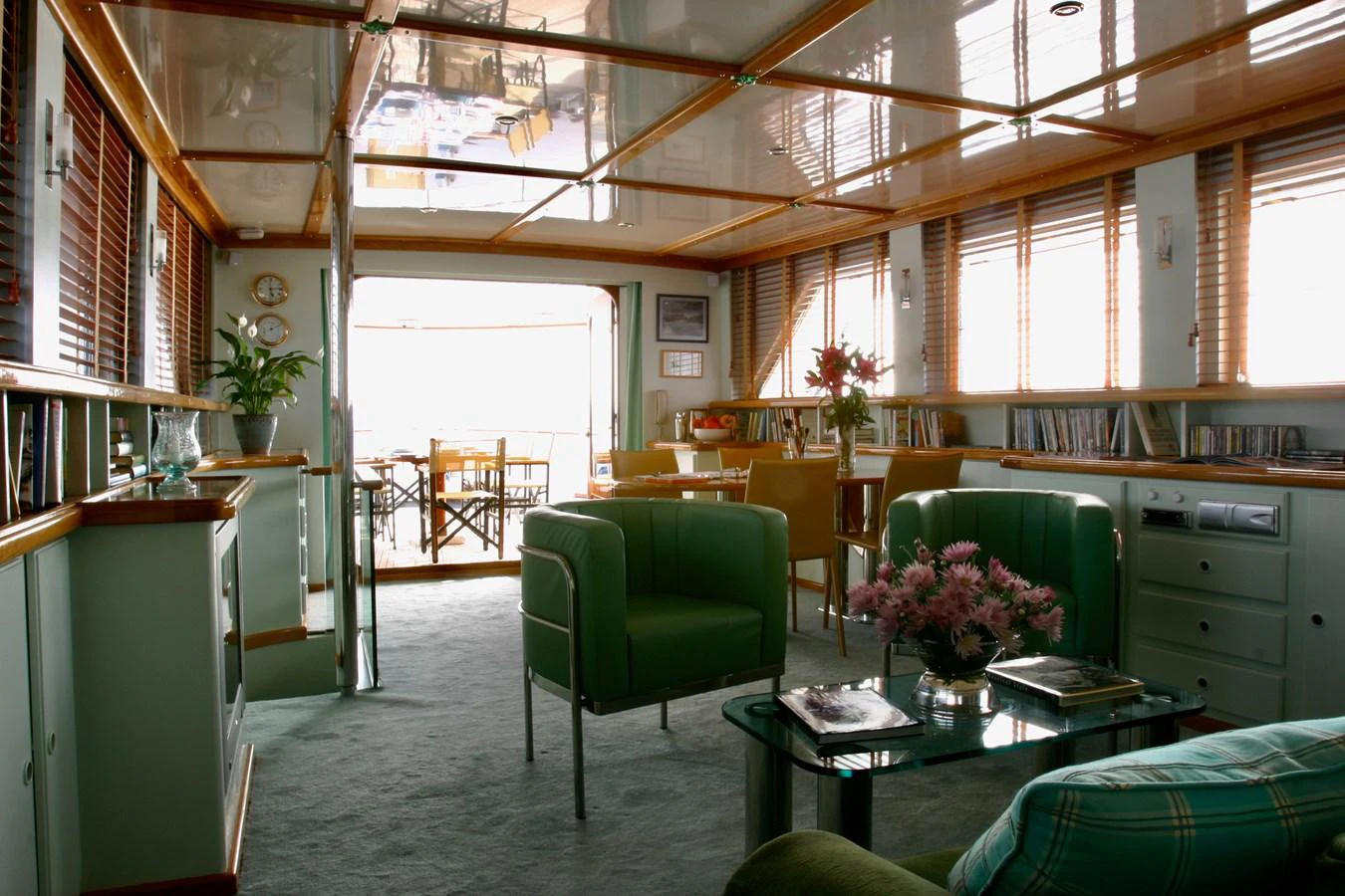 The yacht's salon features comfortable seating, ample natural light, and elegant decor. aboard KALANI Yacht for Sale