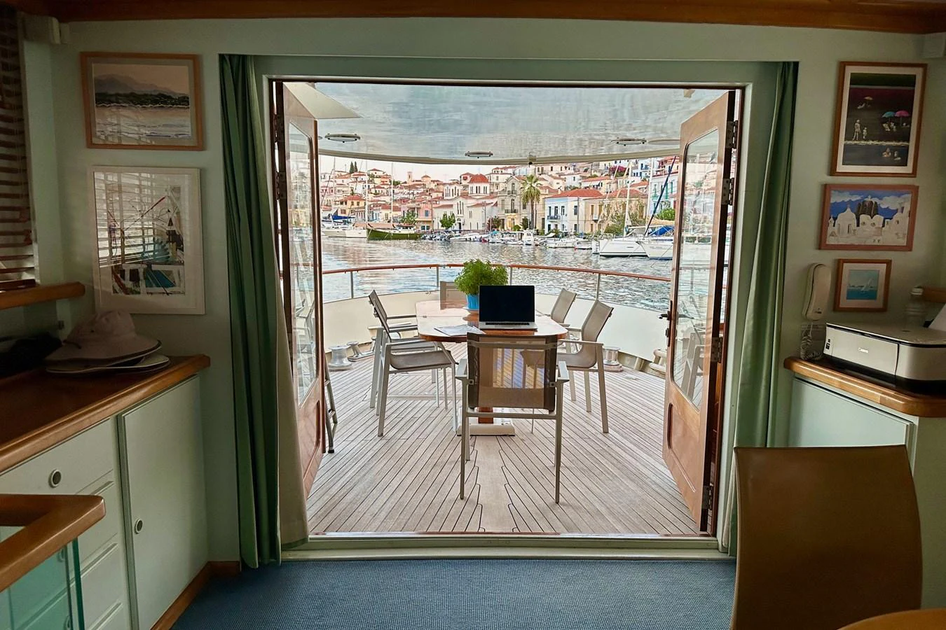 The salon opens up to a charming aft deck with a picturesque view of the harbor. aboard KALANI Yacht for Sale