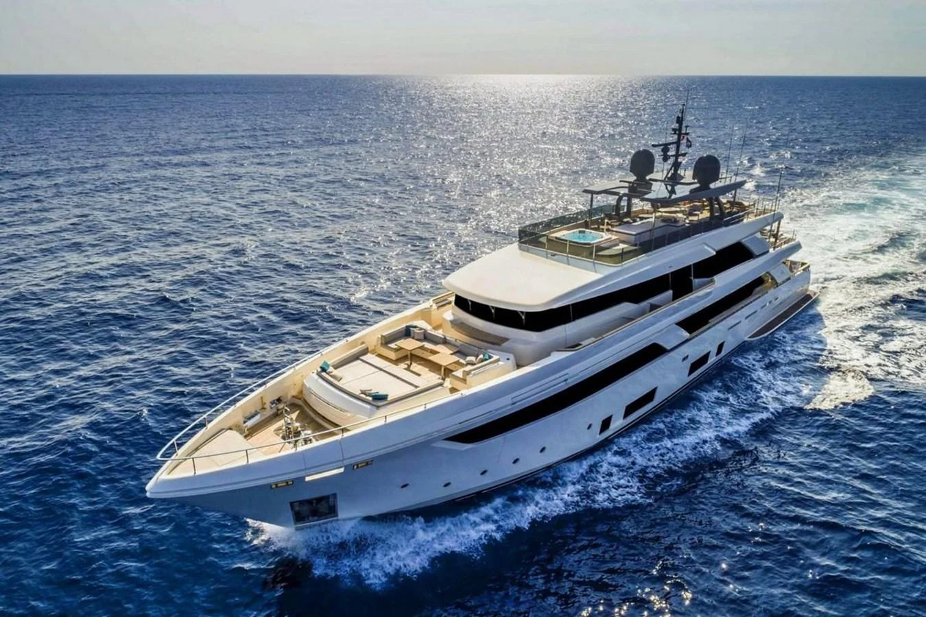 A luxurious yacht cruises through the open sea, showcasing its sleek design and spacious decks. aboard ALBUS Yacht for Sale