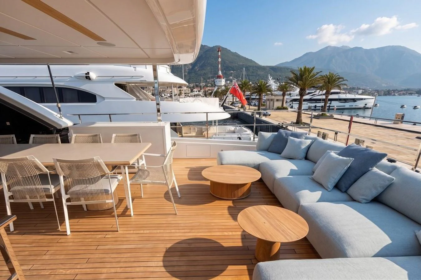 The aft deck features a spacious seating area with plush cushions and a dining table, perfect for outdoor relaxation and dining. aboard ALBUS Yacht for Sale