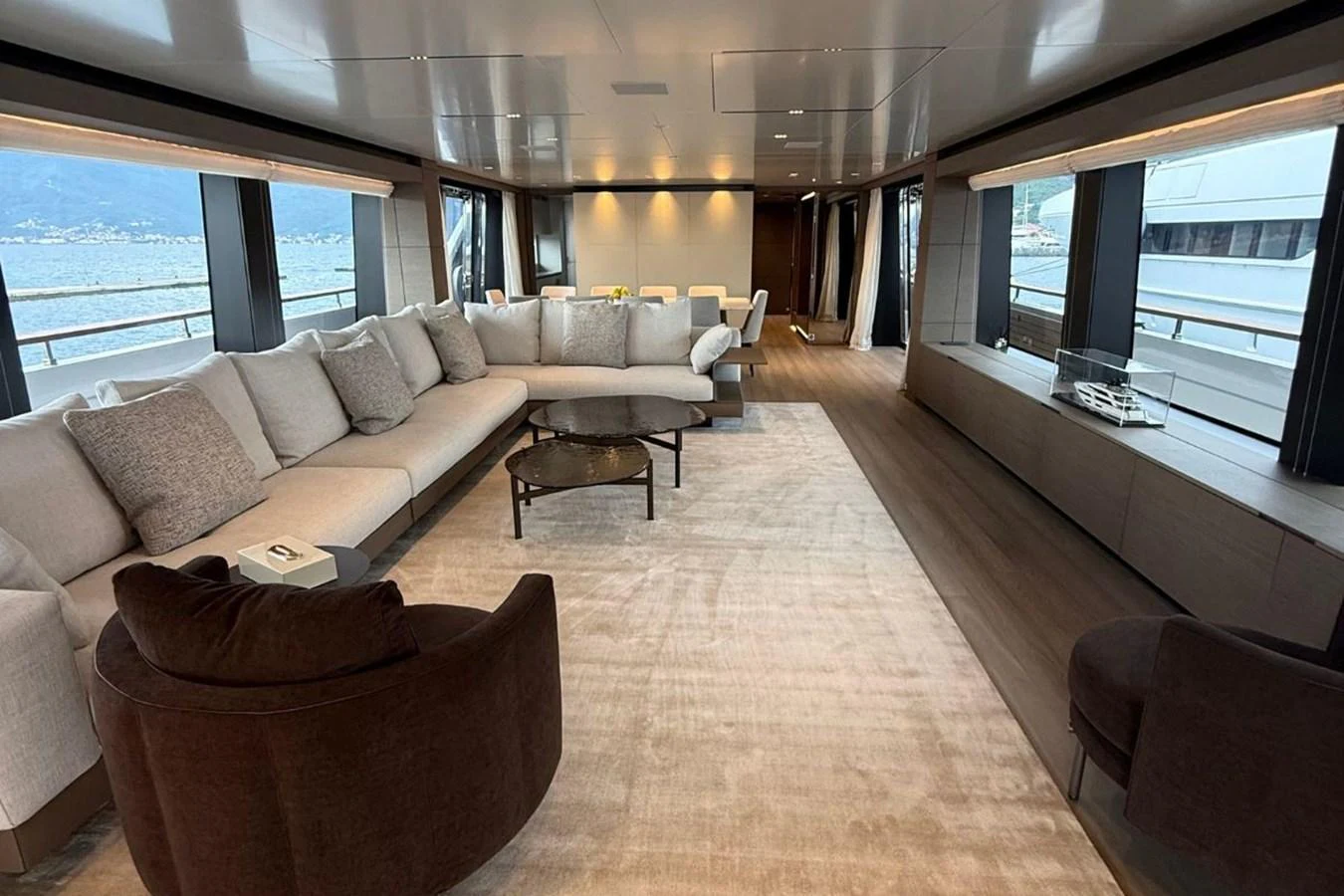 The spacious salon features plush seating and panoramic windows, offering a luxurious and comfortable environment. aboard ALBUS Yacht for Sale