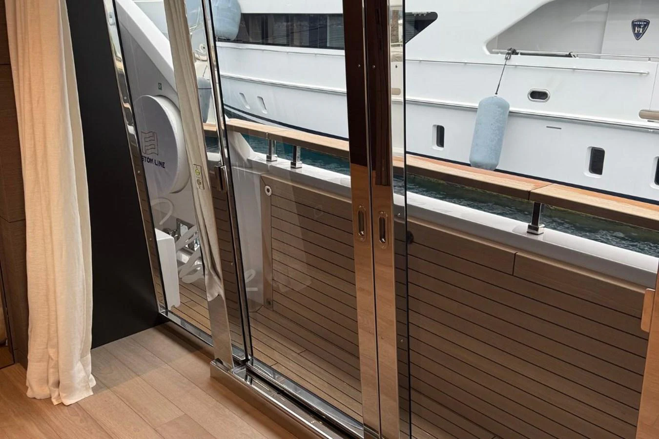A view from inside the yacht looking out through sliding glass doors onto the deck. aboard ALBUS Yacht for Sale