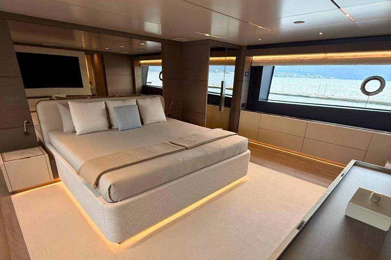 The master stateroom features a luxurious bed with panoramic ocean views through large windows. aboard ALBUS Yacht for Sale