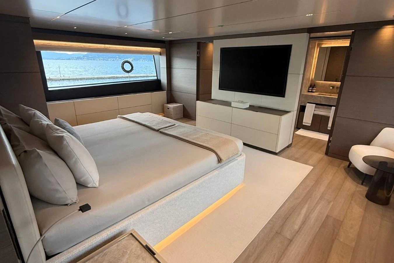 The master stateroom features a spacious layout with a large bed, modern furnishings, and a view of the sea. aboard ALBUS Yacht for Sale