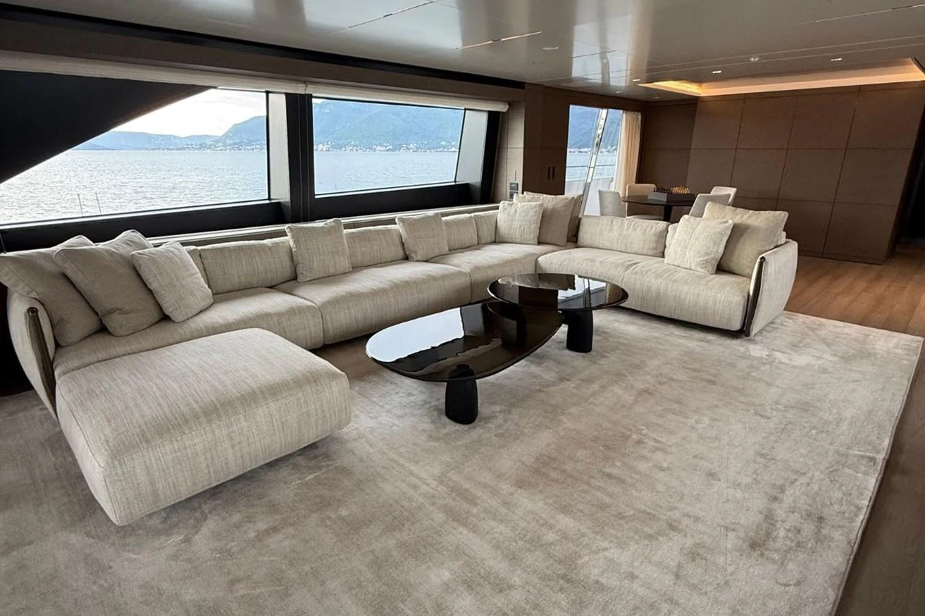 The salon features a spacious and elegant seating area with large windows offering stunning views. aboard ALBUS Yacht for Sale