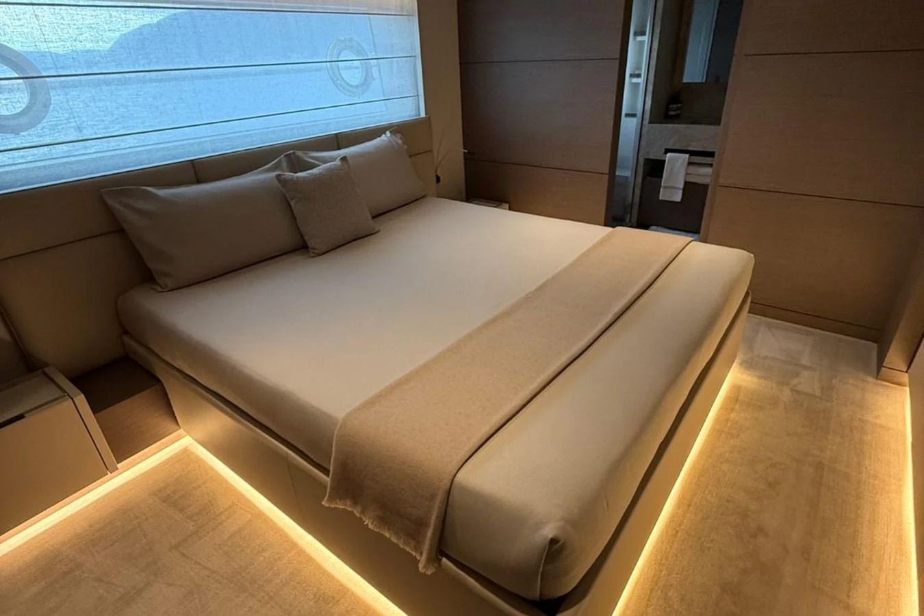 The stateroom features a luxurious bed with ambient lighting and modern decor. aboard ALBUS Yacht for Sale