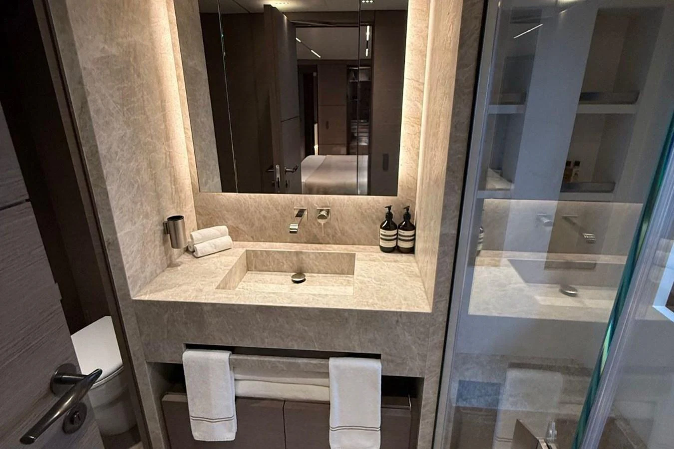 The yacht's bathroom features a sleek, modern design with elegant fixtures and ample lighting. aboard ALBUS Yacht for Sale