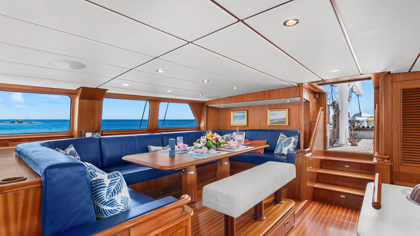The salon features a spacious seating area with large windows offering stunning ocean views. aboard ISLANDIA Yacht for Sale
