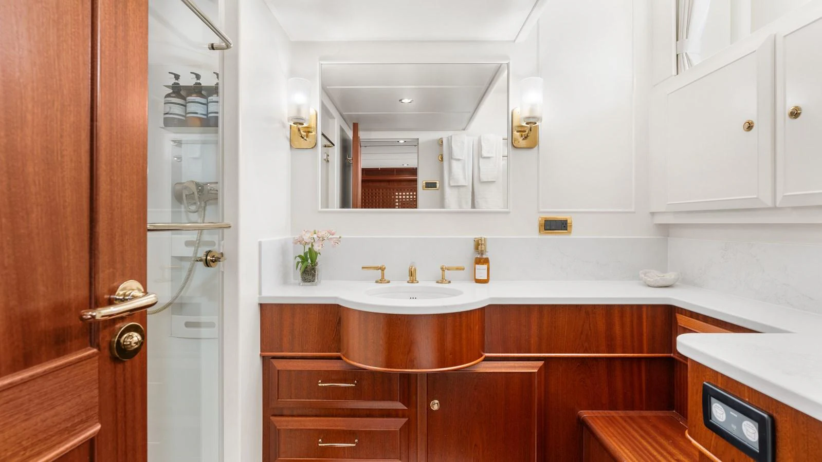 The yacht's bathroom features elegant wood cabinetry and modern fixtures, creating a luxurious and inviting space. aboard ISLANDIA Yacht for Sale