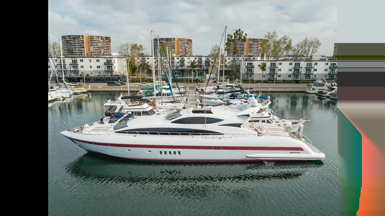 A sleek and modern yacht is docked in a marina, showcasing its elegant profile and luxurious design. aboard SAIGON Yacht for Sale