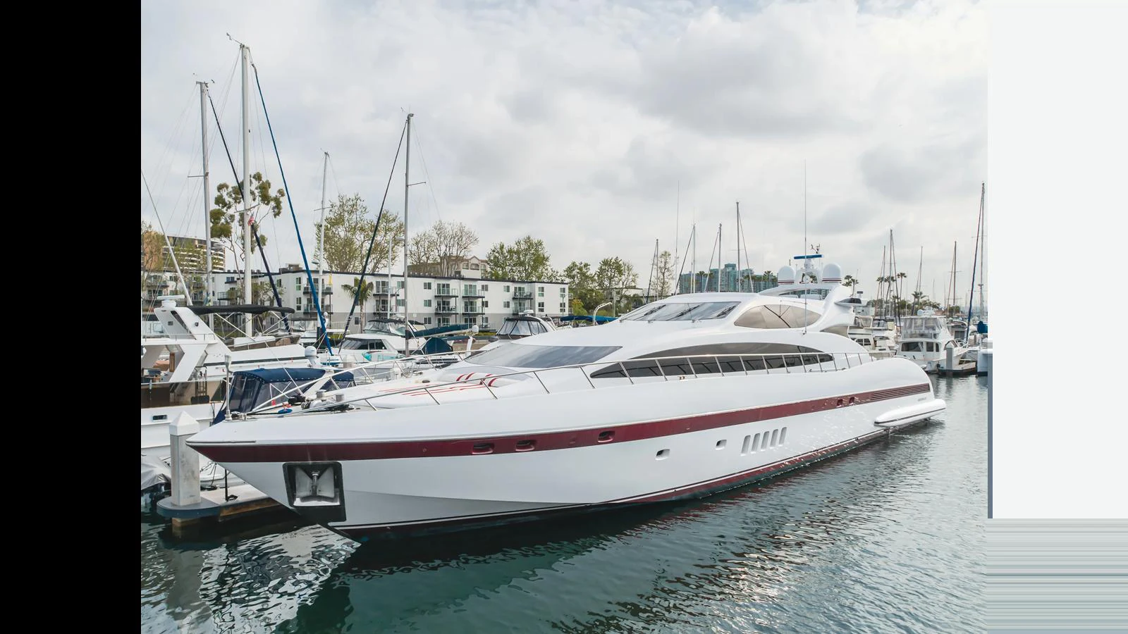 A sleek, modern yacht is docked in a marina, showcasing its elegant lines and spacious design. aboard SAIGON Yacht for Sale