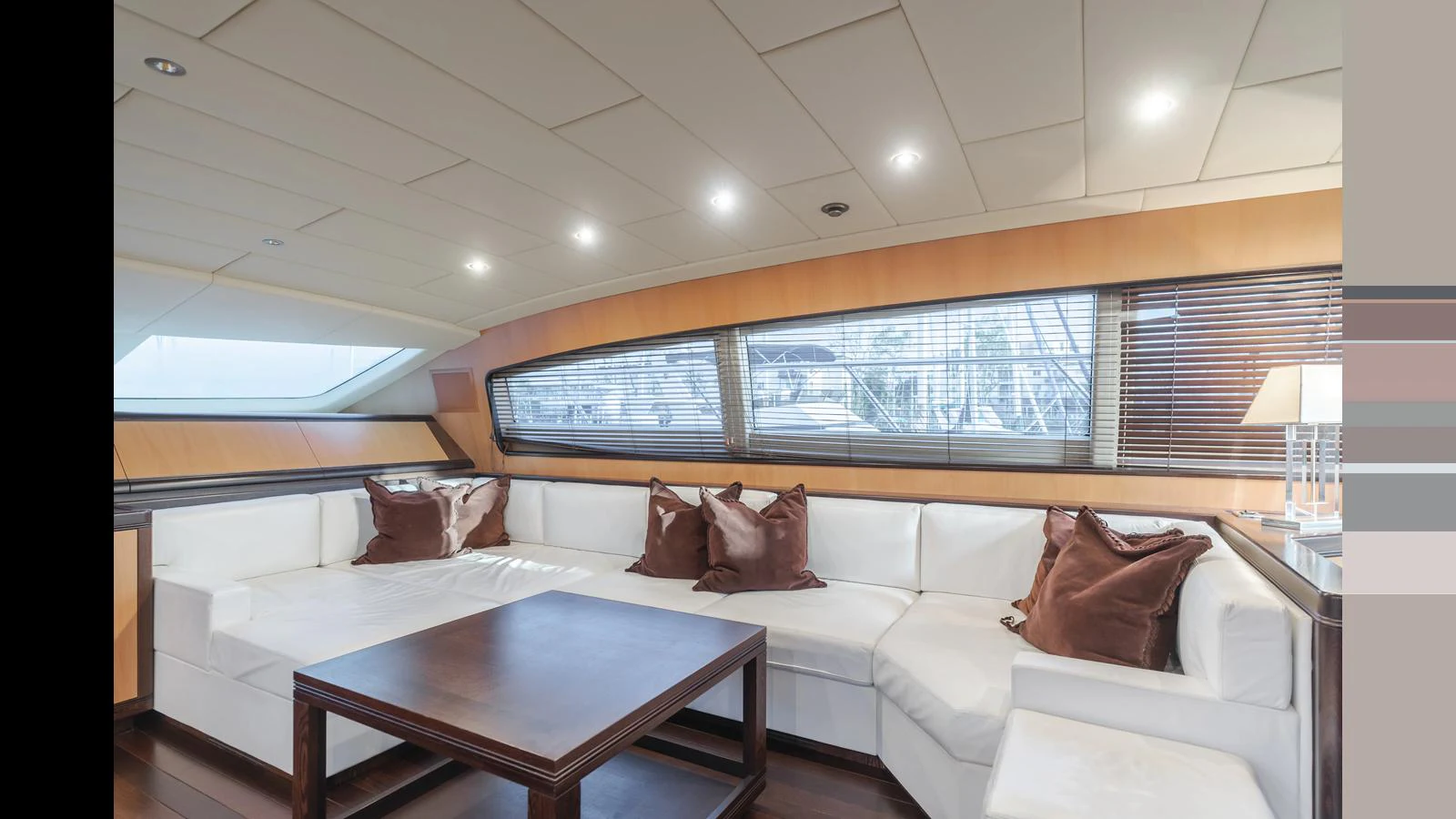 The salon features a spacious and elegant seating area with large windows providing ample natural light. aboard SAIGON Yacht for Sale