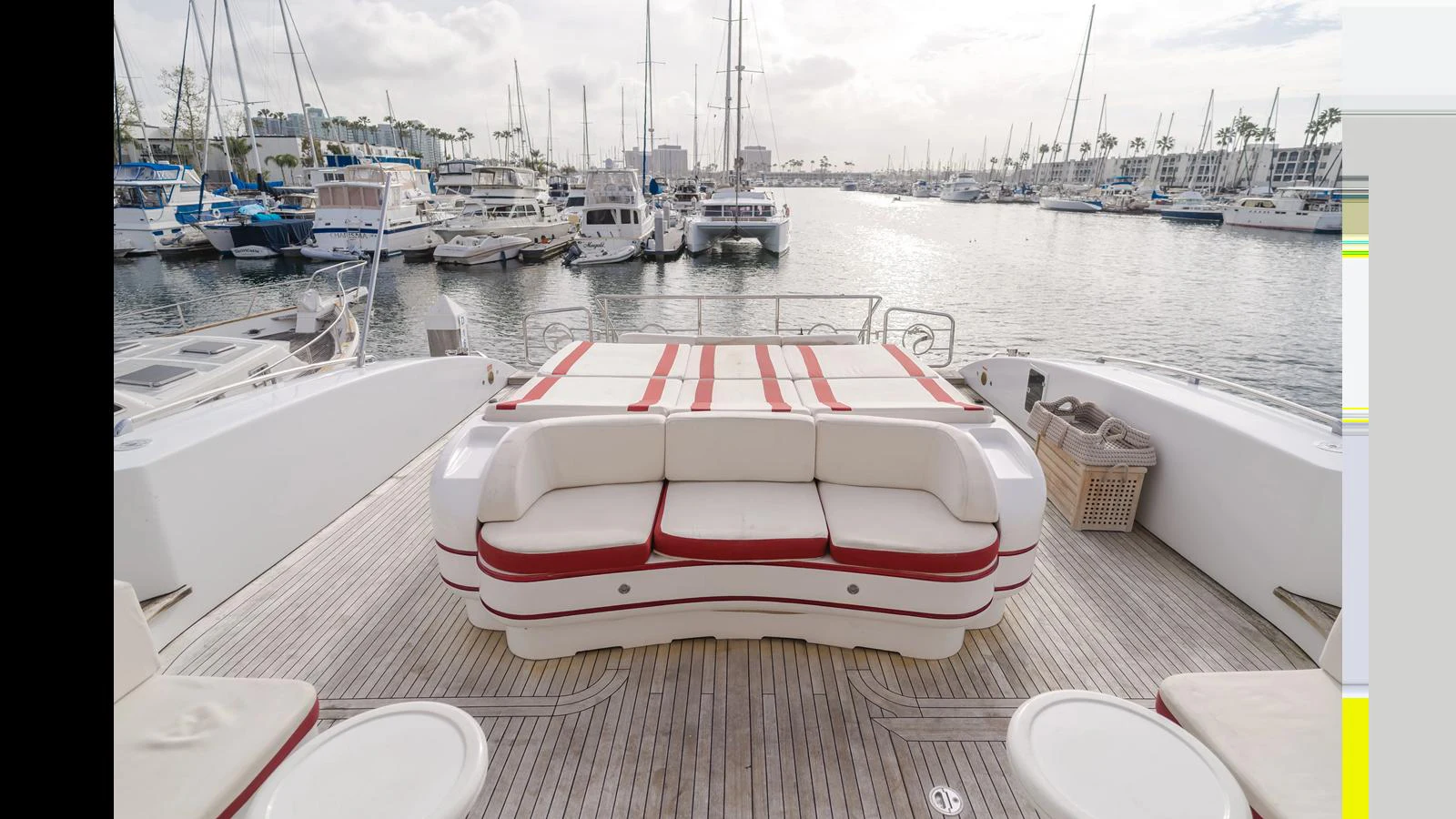 The aft deck features a spacious seating area with a view of the marina. aboard SAIGON Yacht for Sale
