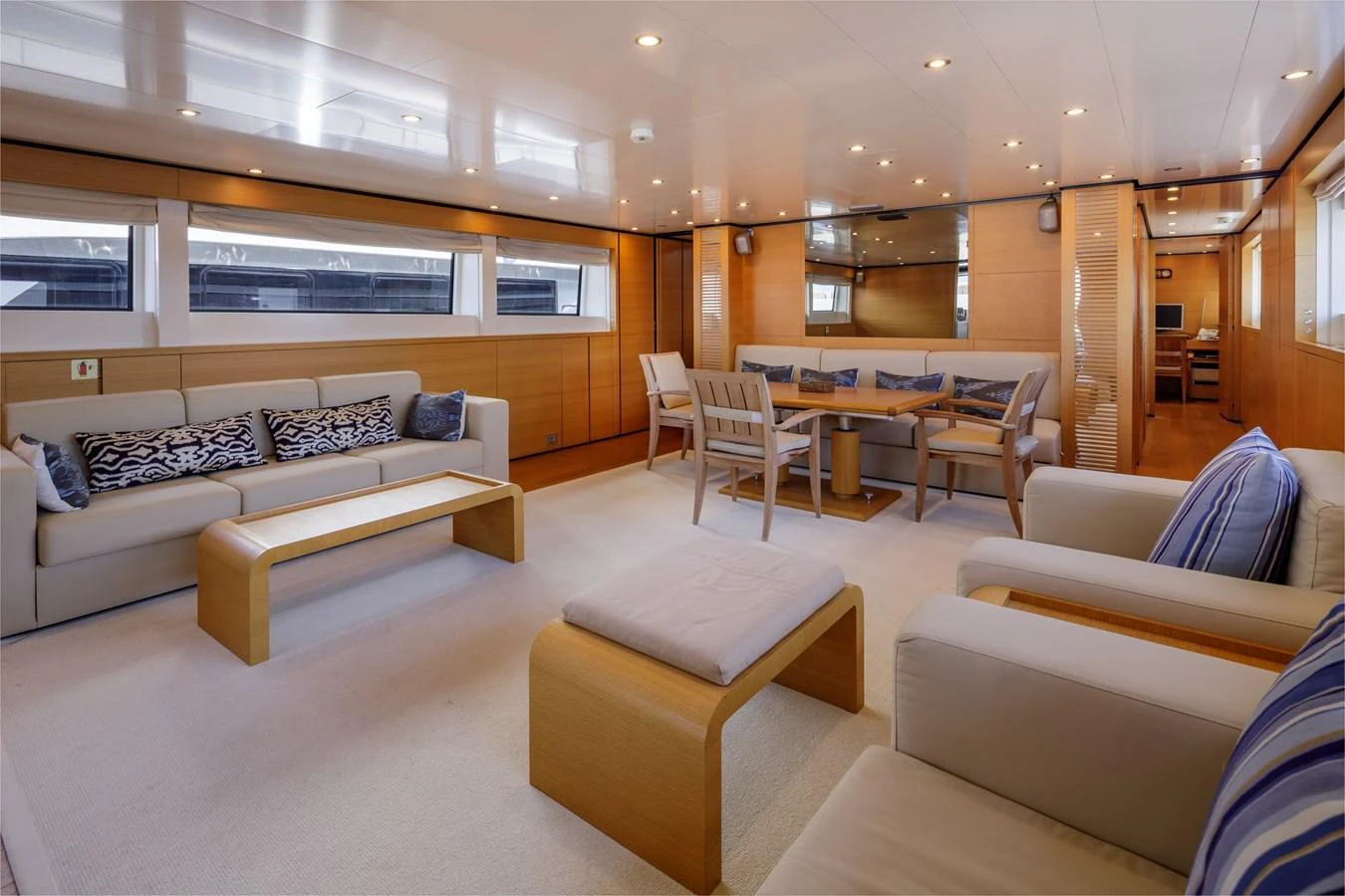 The salon features a spacious and elegantly furnished seating area with ample natural light. aboard BOLARO Yacht for Sale
