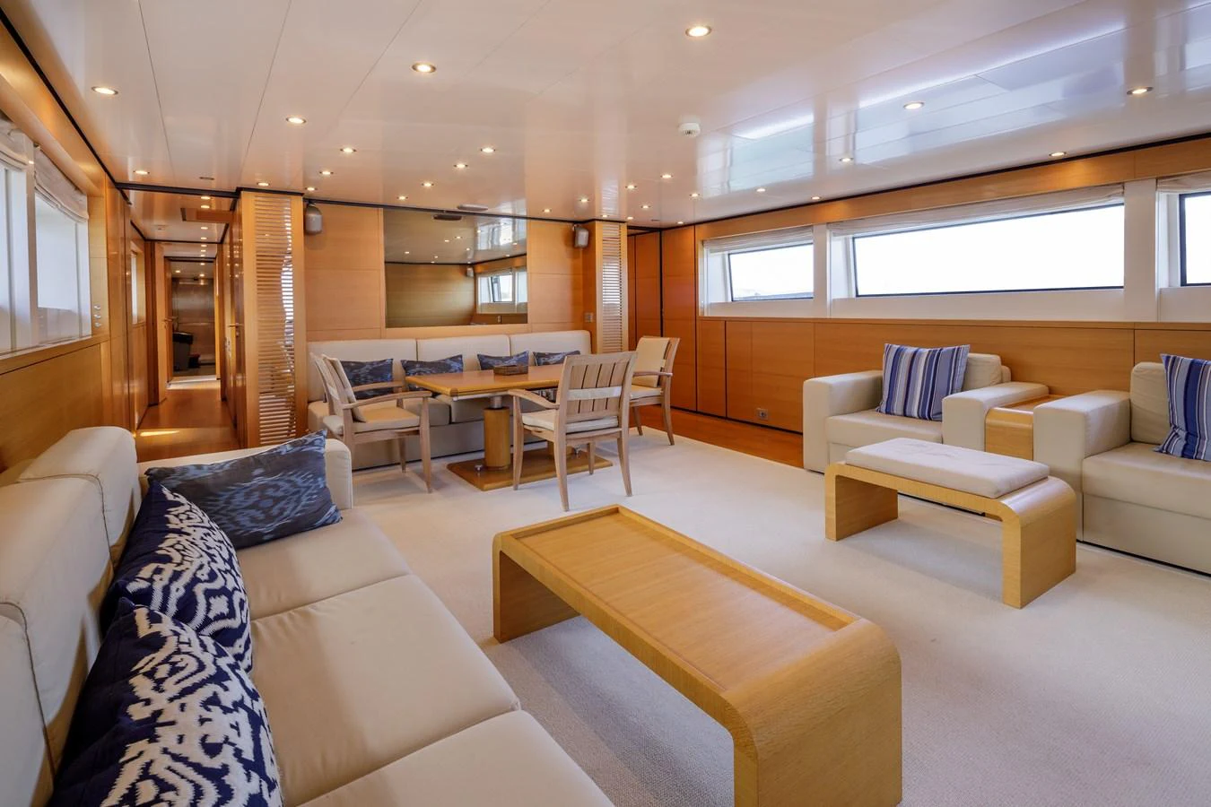 The spacious salon features comfortable seating and elegant wooden furnishings, creating a warm and inviting atmosphere. aboard BOLARO Yacht for Sale