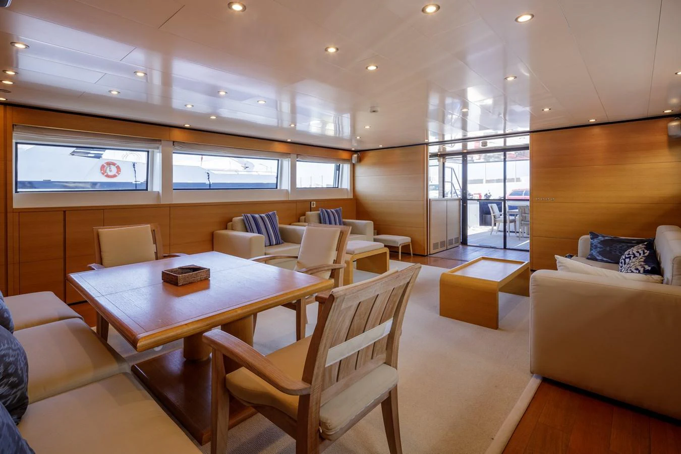 The salon features comfortable seating, a dining area, and large windows for natural light. aboard BOLARO Yacht for Sale