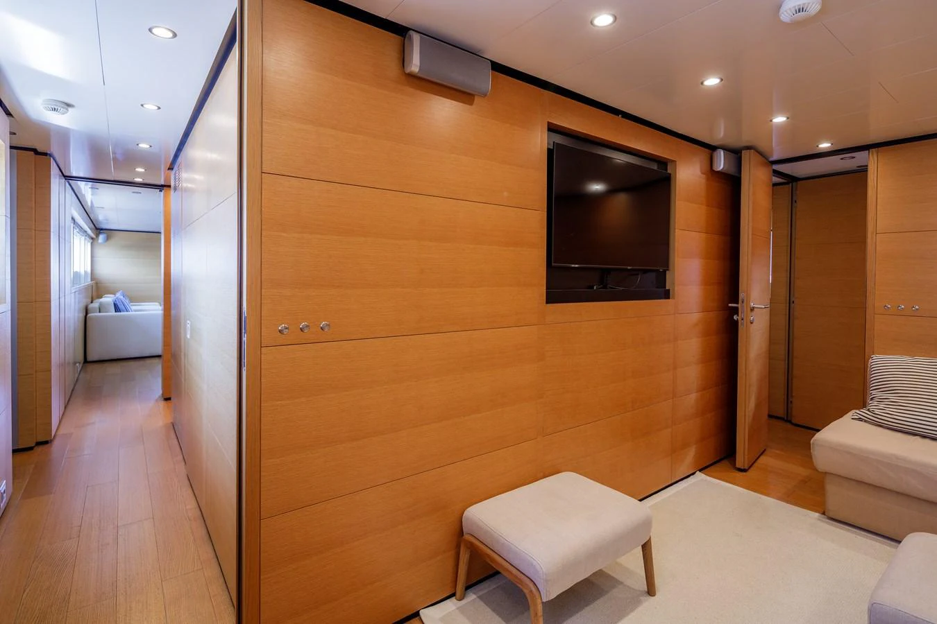 The yacht's interior features a cozy lounge area with wooden paneling and modern amenities. aboard BOLARO Yacht for Sale
