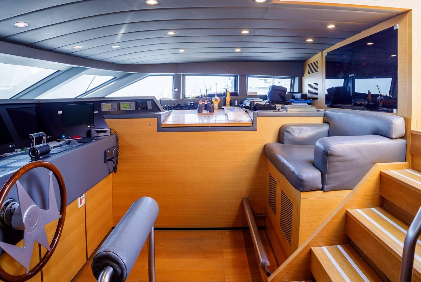 The helm station features modern navigation equipment and a comfortable seating area. aboard BOLARO Yacht for Sale