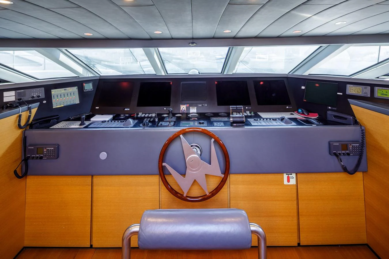 The helm station features advanced navigation equipment and a sleek, modern design. aboard BOLARO Yacht for Sale