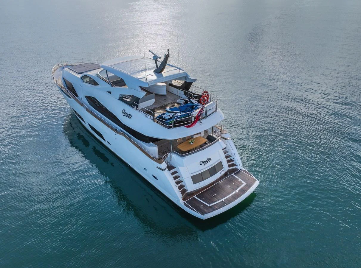 A sleek and modern yacht glides gracefully on calm waters, showcasing its elegant design and spacious decks. aboard CLOUDIA Yacht for Sale