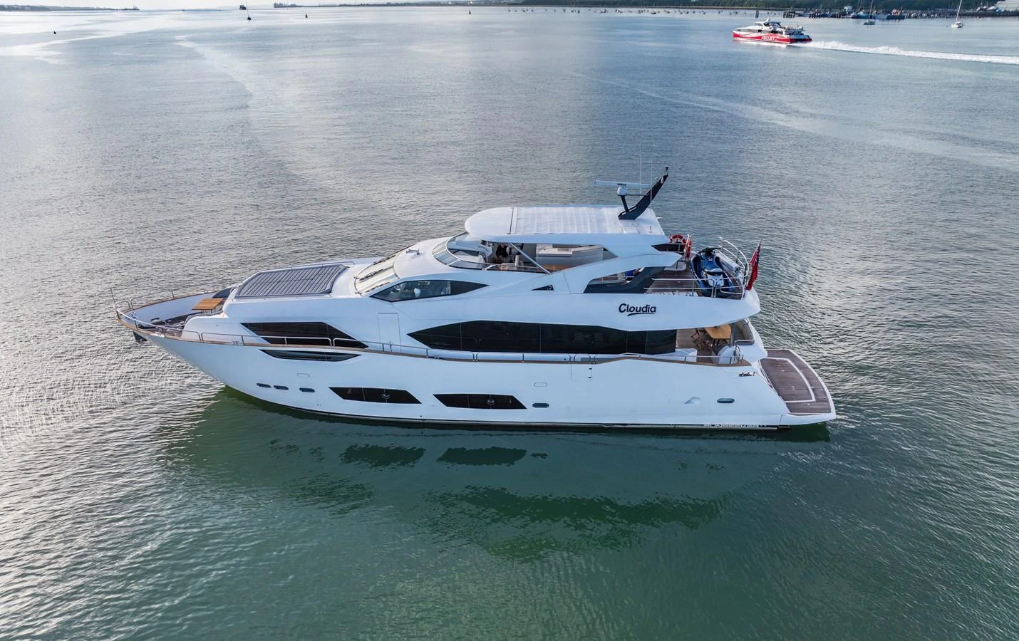A sleek and modern yacht glides gracefully on calm waters, showcasing its elegant design and spacious decks. aboard CLOUDIA Yacht for Sale