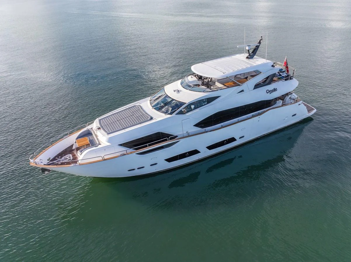 A sleek and modern yacht glides gracefully on calm waters, showcasing its luxurious design and spacious decks. aboard CLOUDIA Yacht for Sale