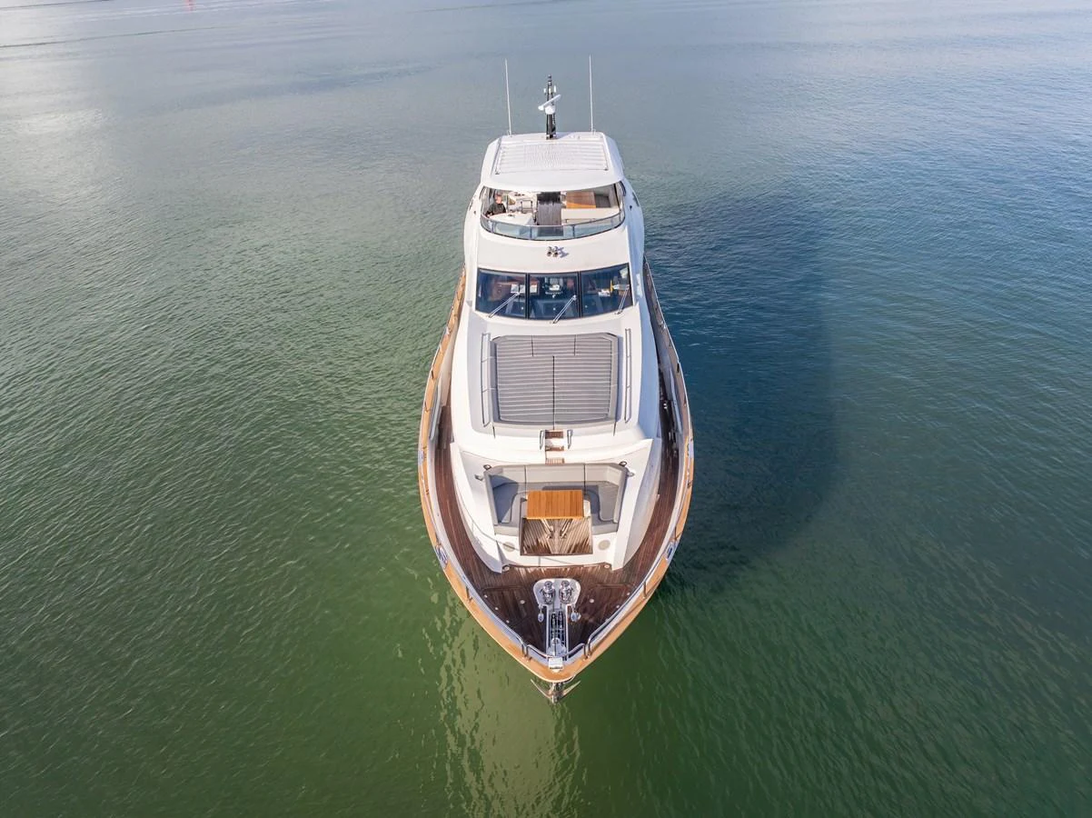 An aerial view of a sleek yacht cruising on calm waters. aboard CLOUDIA Yacht for Sale