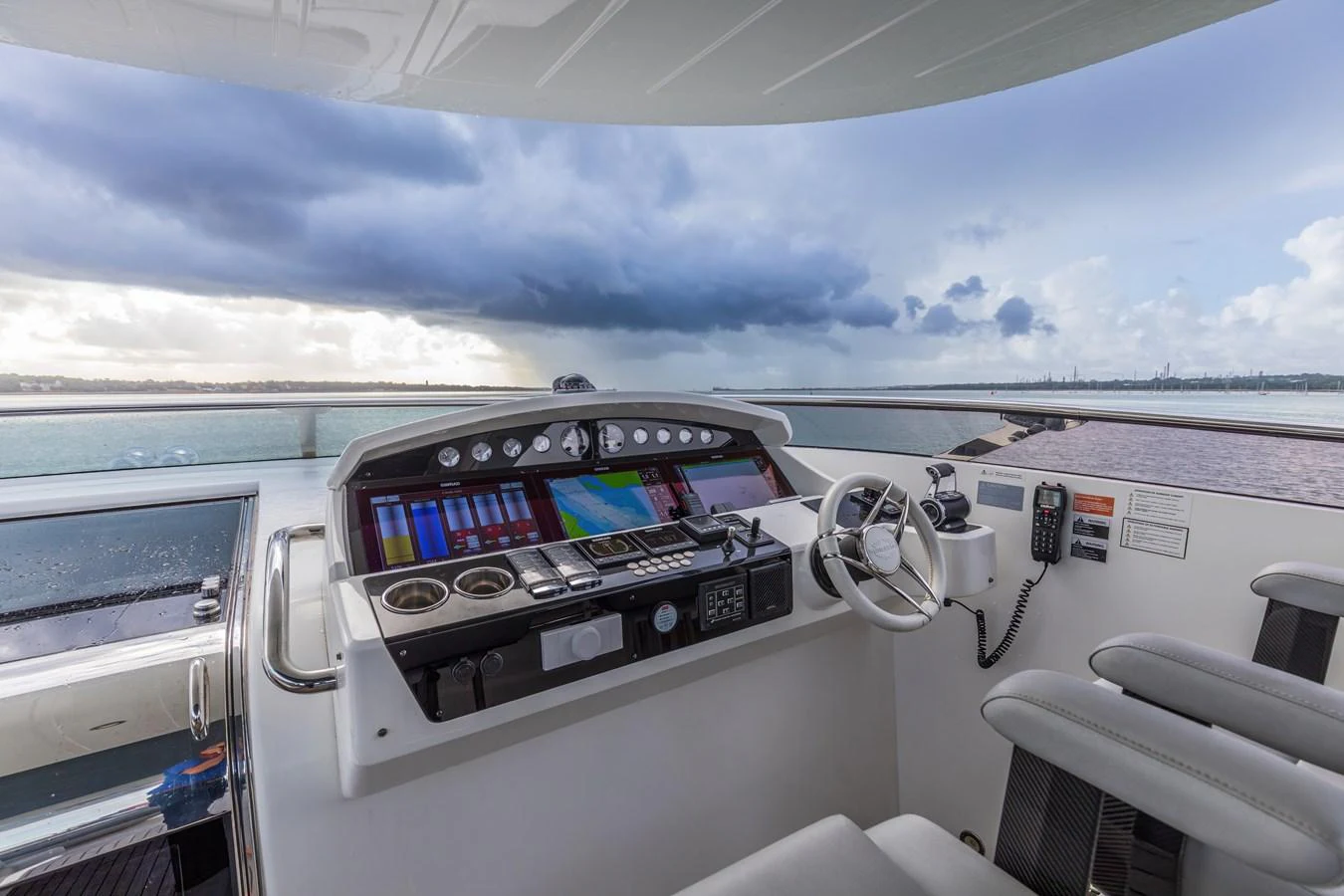 The helm station offers a commanding view with state-of-the-art navigation equipment and comfortable seating. aboard CLOUDIA Yacht for Sale
