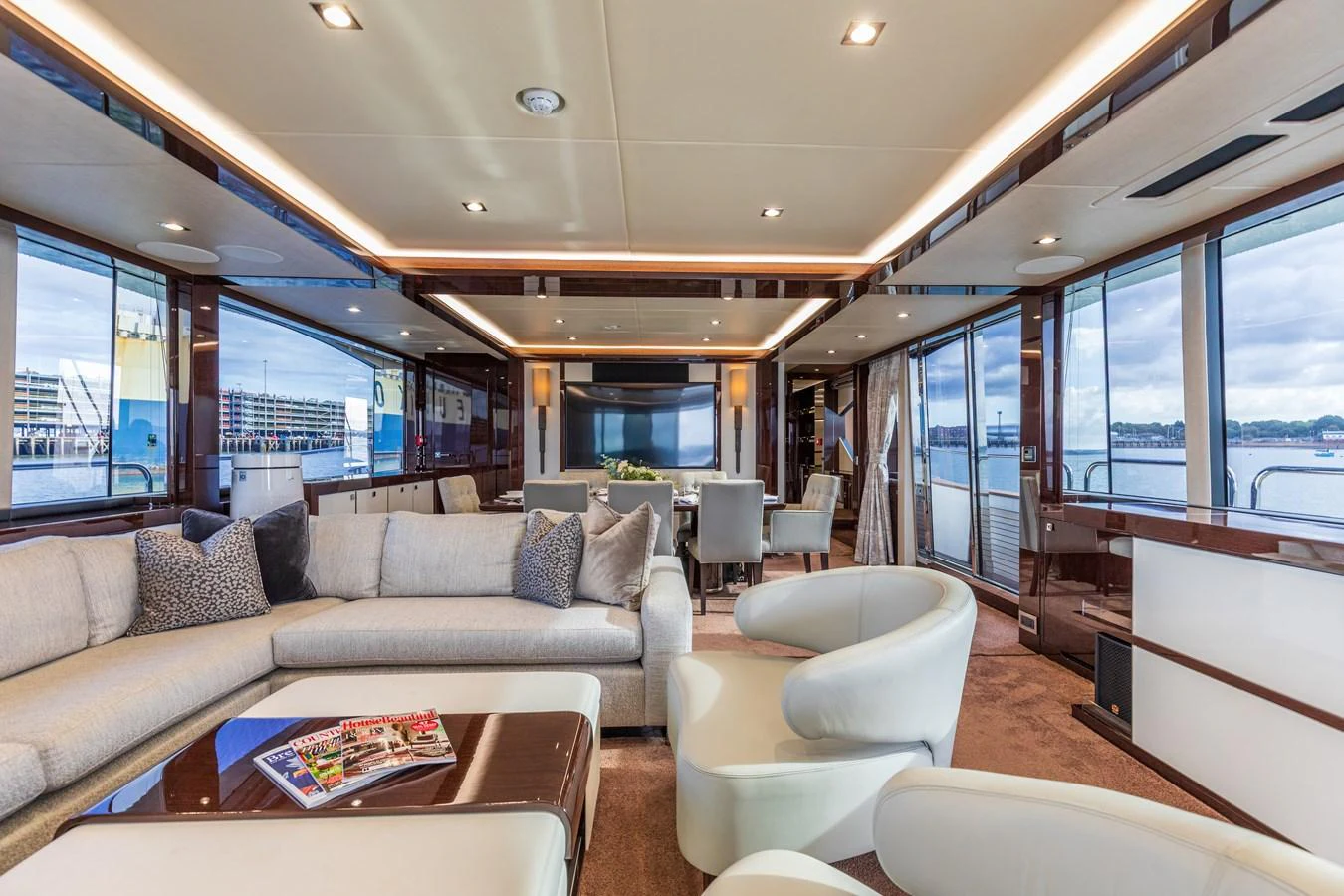 The spacious salon features luxurious seating and panoramic windows offering stunning views. aboard CLOUDIA Yacht for Sale