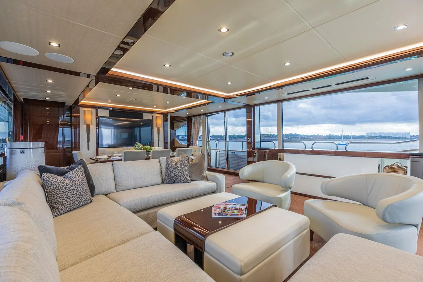 The spacious salon features plush seating and panoramic windows offering stunning views. aboard CLOUDIA Yacht for Sale