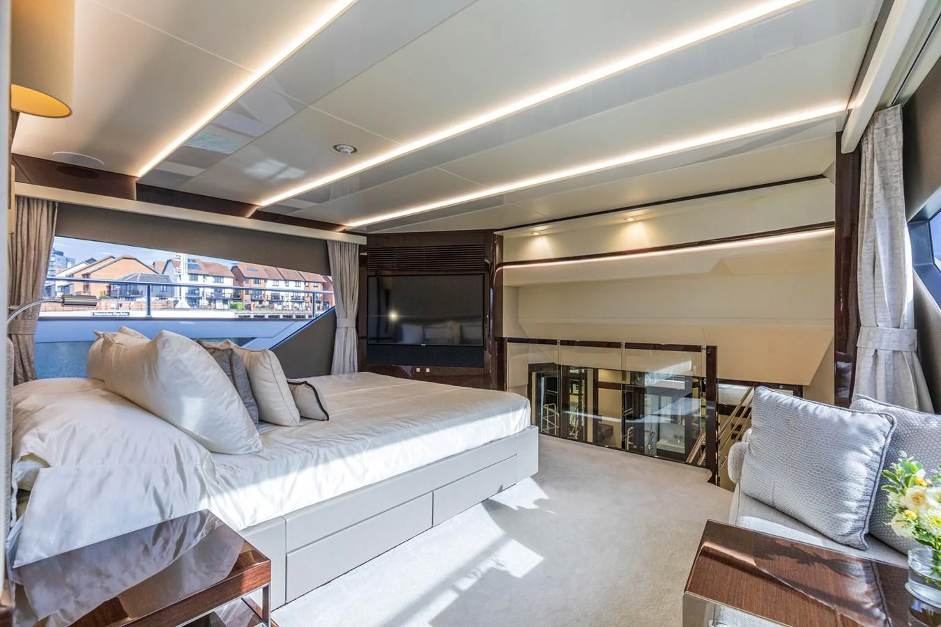 The master stateroom features a spacious bed, elegant decor, and ample natural light. aboard CLOUDIA Yacht for Sale