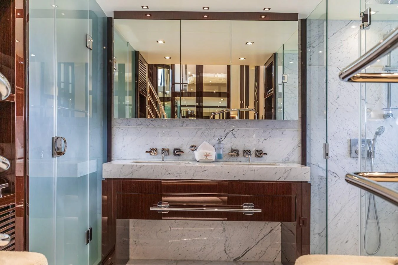 A luxurious yacht bathroom featuring elegant marble surfaces and modern fixtures. aboard CLOUDIA Yacht for Sale