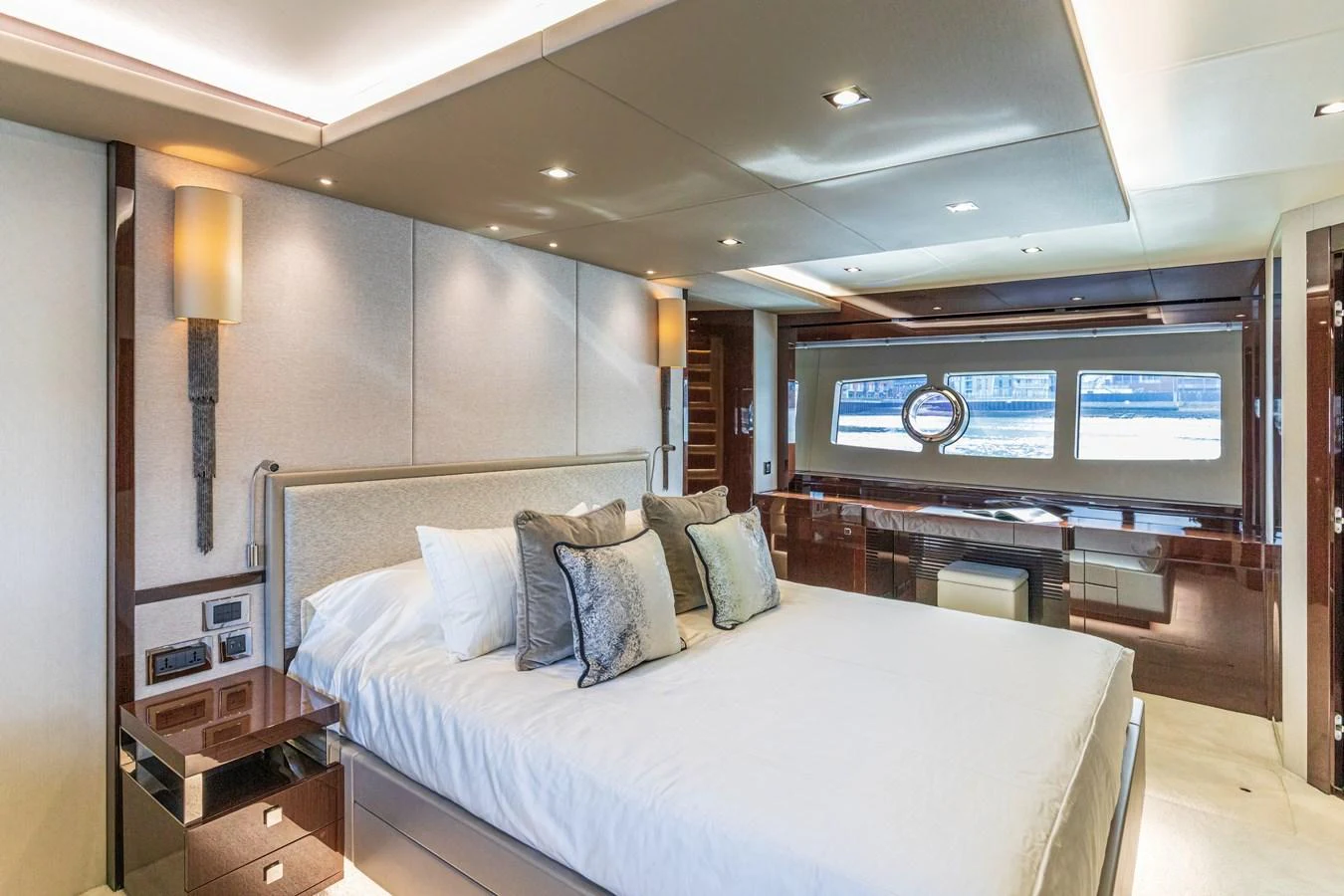 The master stateroom features a luxurious bed, elegant decor, and large windows offering stunning views. aboard CLOUDIA Yacht for Sale