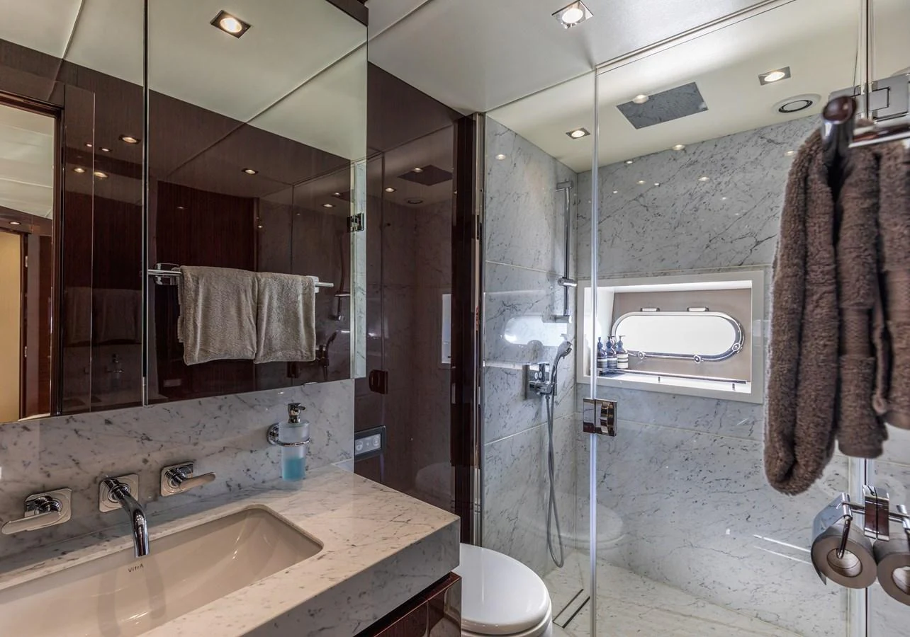 The yacht's bathroom features elegant marble surfaces and modern fixtures. aboard CLOUDIA Yacht for Sale