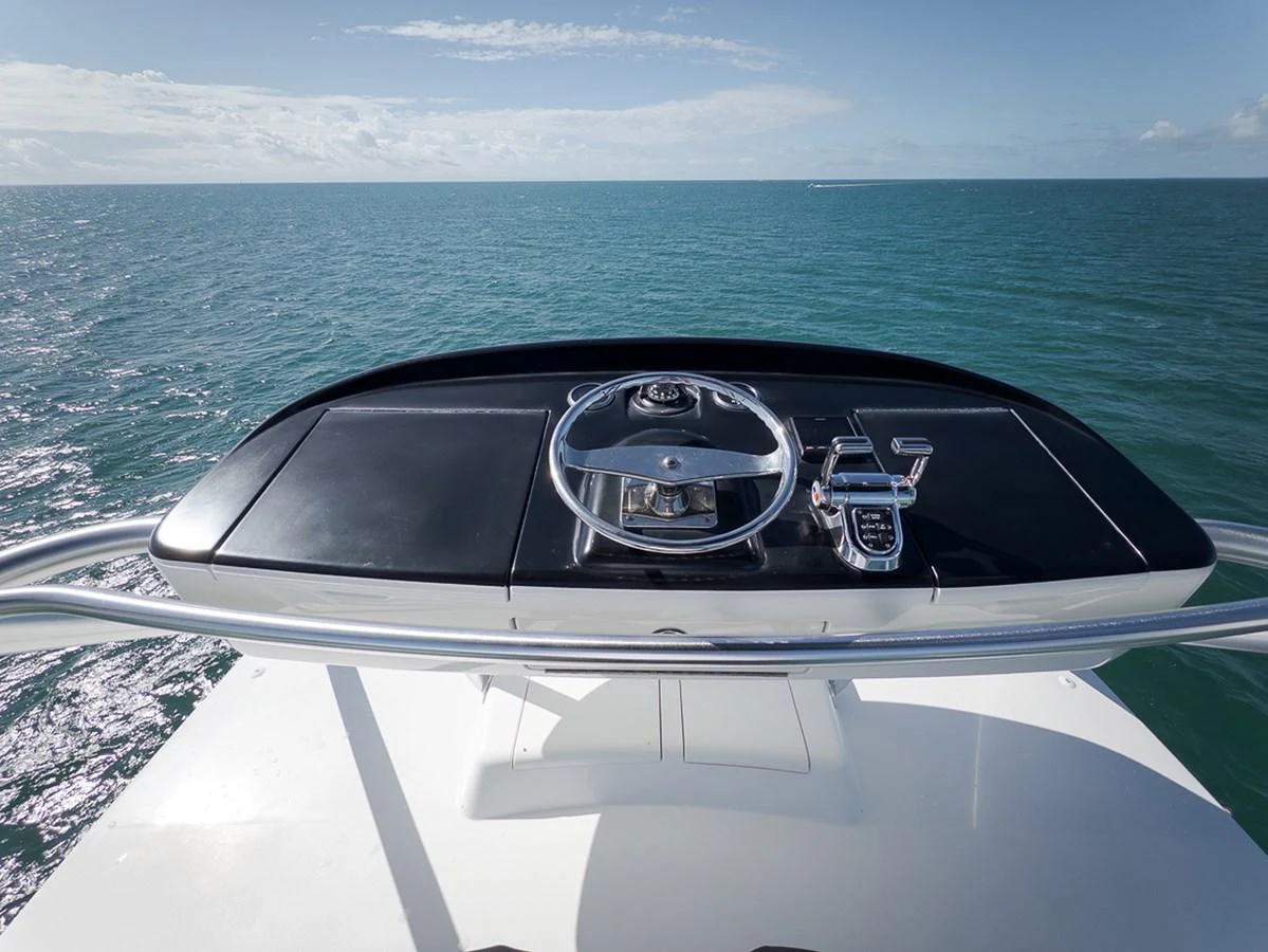 The helm station offers a sleek and modern control area with a stunning ocean view. aboard REEL HAWK Yacht for Sale
