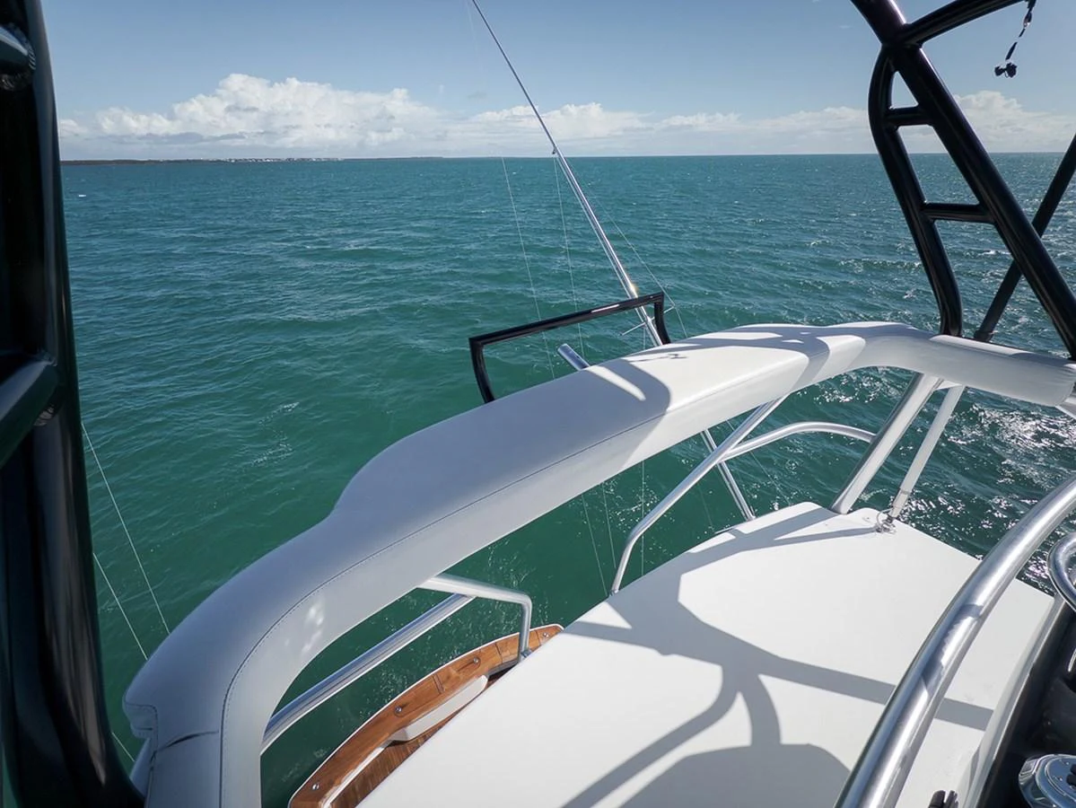 The flybridge offers a stunning view of the open sea, perfect for navigating and relaxing. aboard REEL HAWK Yacht for Sale