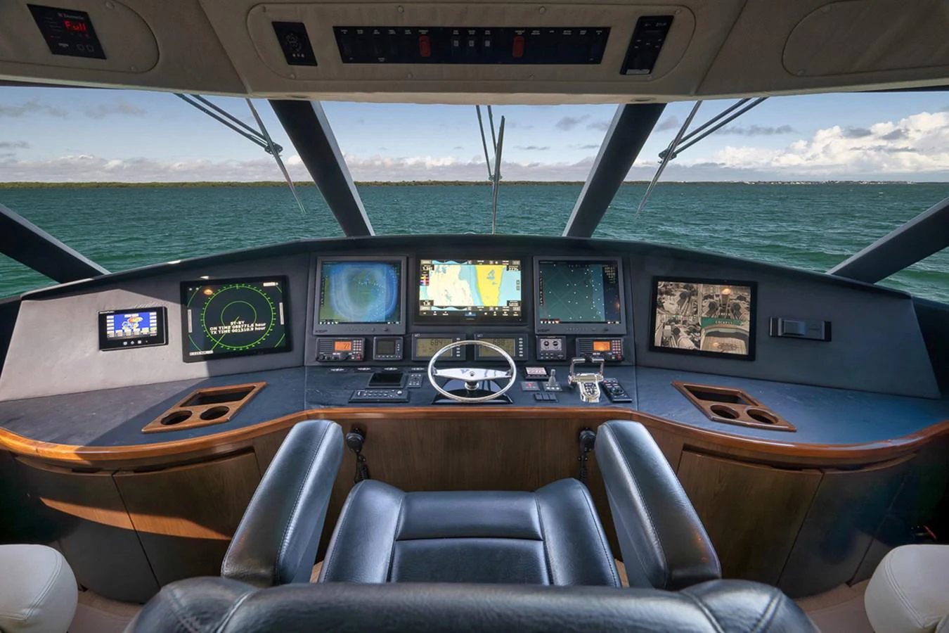 The helm offers a commanding view with advanced navigation systems and luxurious seating. aboard REEL HAWK Yacht for Sale