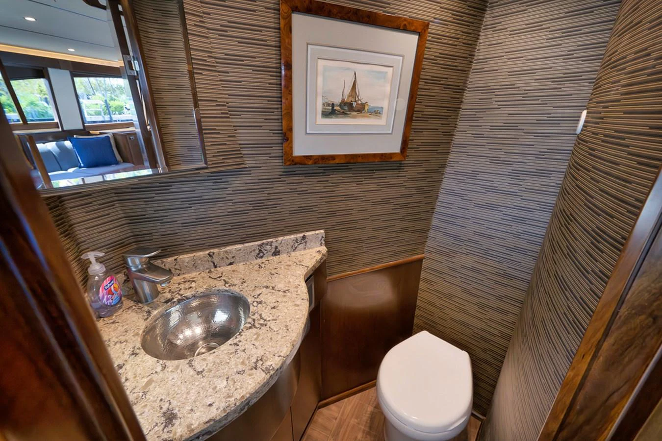 A well-appointed yacht head featuring a granite countertop and modern fixtures. aboard REEL HAWK Yacht for Sale
