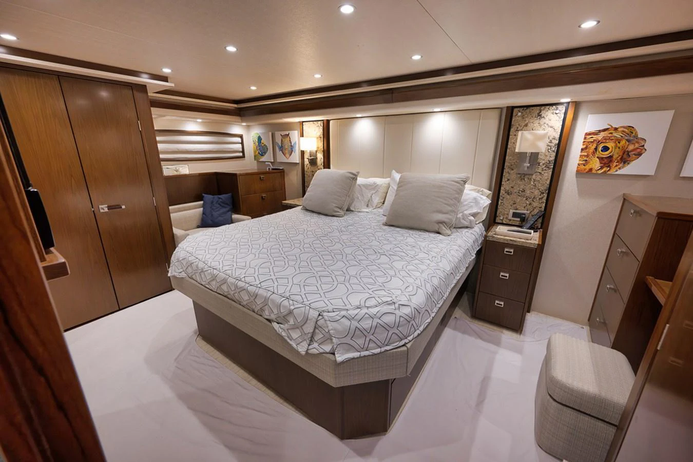 The master stateroom features a luxurious bed with elegant decor and ample storage. aboard REEL HAWK Yacht for Sale