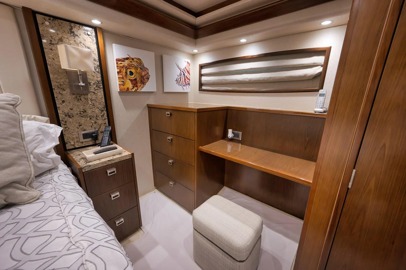 A cozy stateroom with elegant wood finishes and modern decor. aboard REEL HAWK Yacht for Sale