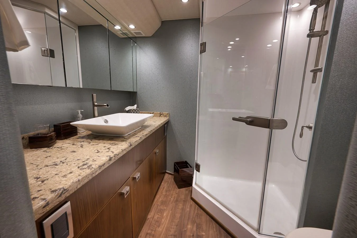 The yacht's bathroom features a modern design with a spacious shower and elegant fixtures. aboard REEL HAWK Yacht for Sale