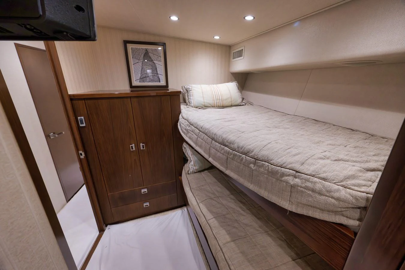 The guest cabin features cozy bunk beds and warm wood finishes, creating a comfortable and inviting space. aboard REEL HAWK Yacht for Sale