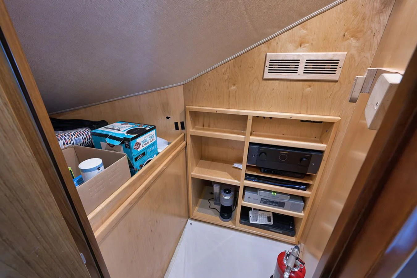 A compact storage area with shelves and various equipment neatly organized. aboard REEL HAWK Yacht for Sale