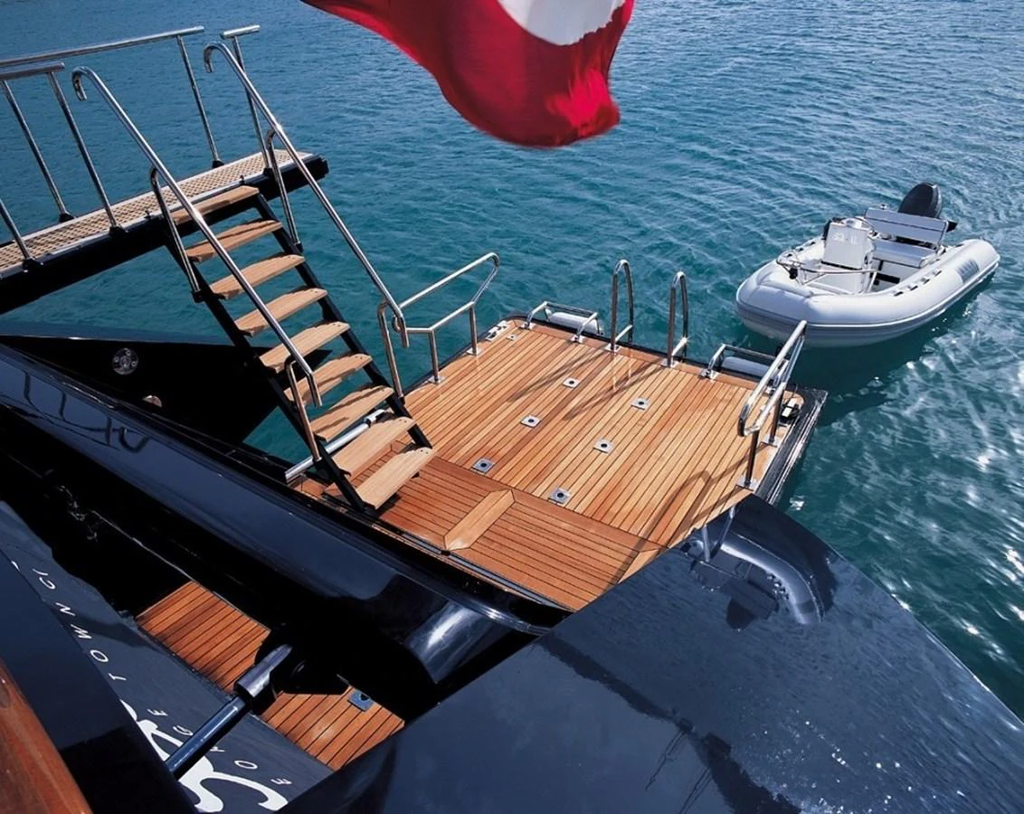 The yacht features a spacious swim platform with easy access to the water and a tender. aboard SQUALL Yacht for Sale