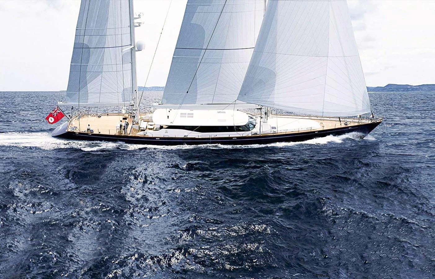 A sleek sailing yacht glides gracefully across the open sea, showcasing its elegant design and impressive sails. aboard SQUALL Yacht for Sale