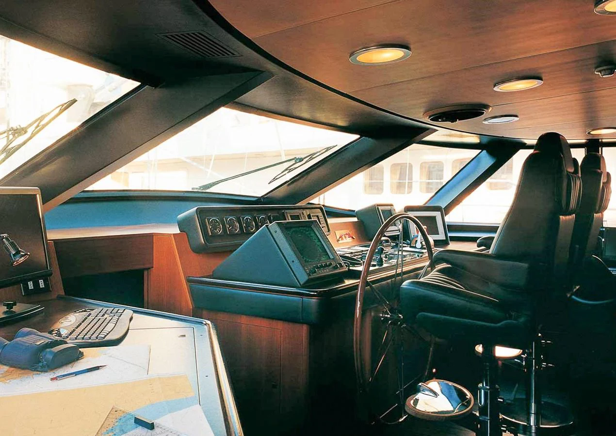 The helm station features advanced navigation equipment and luxurious seating, ensuring a comfortable and efficient command center. aboard SQUALL Yacht for Sale