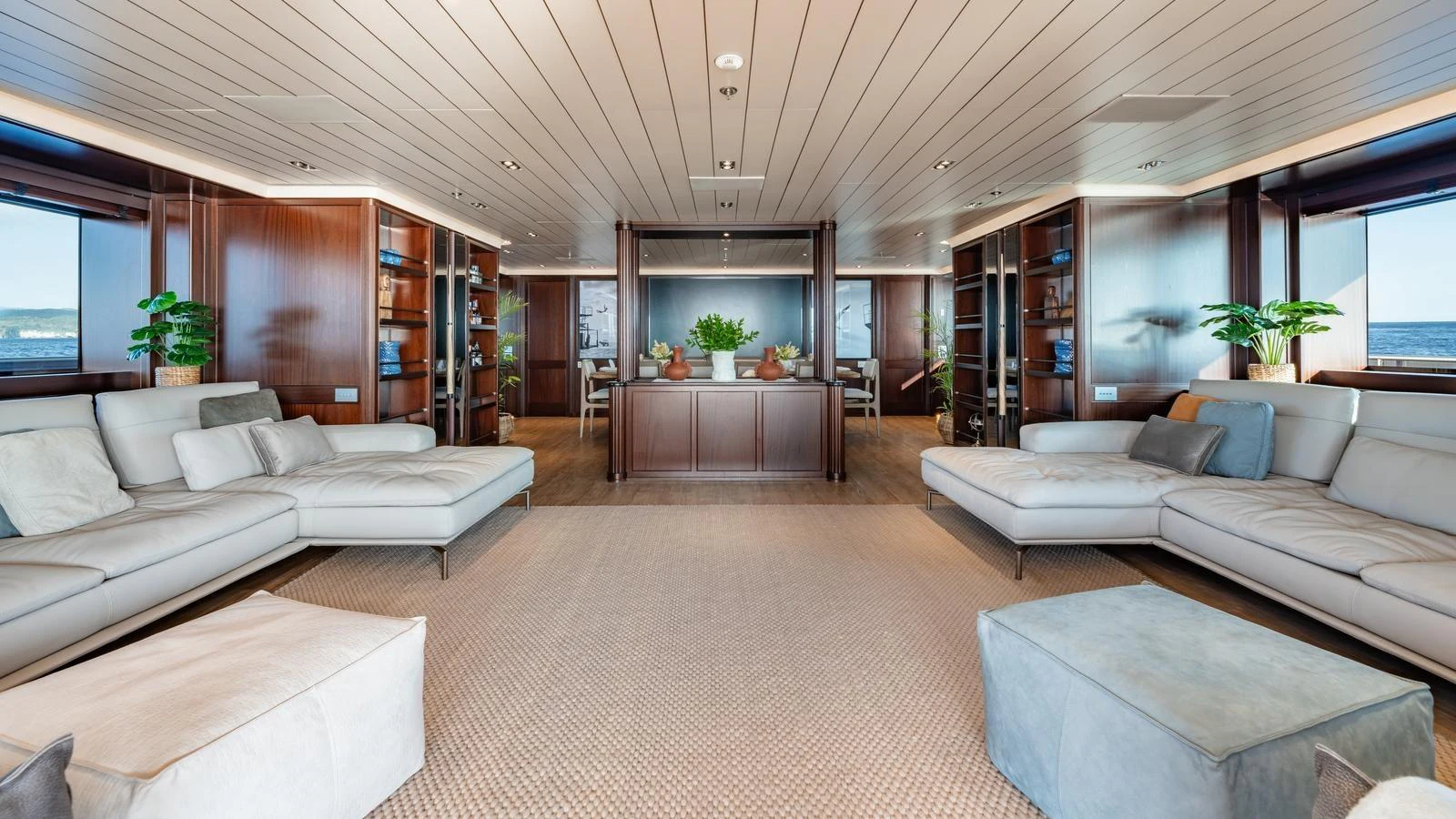 The spacious salon features plush seating, elegant wood paneling, and large windows offering stunning sea views. aboard GALILEO Yacht for Sale